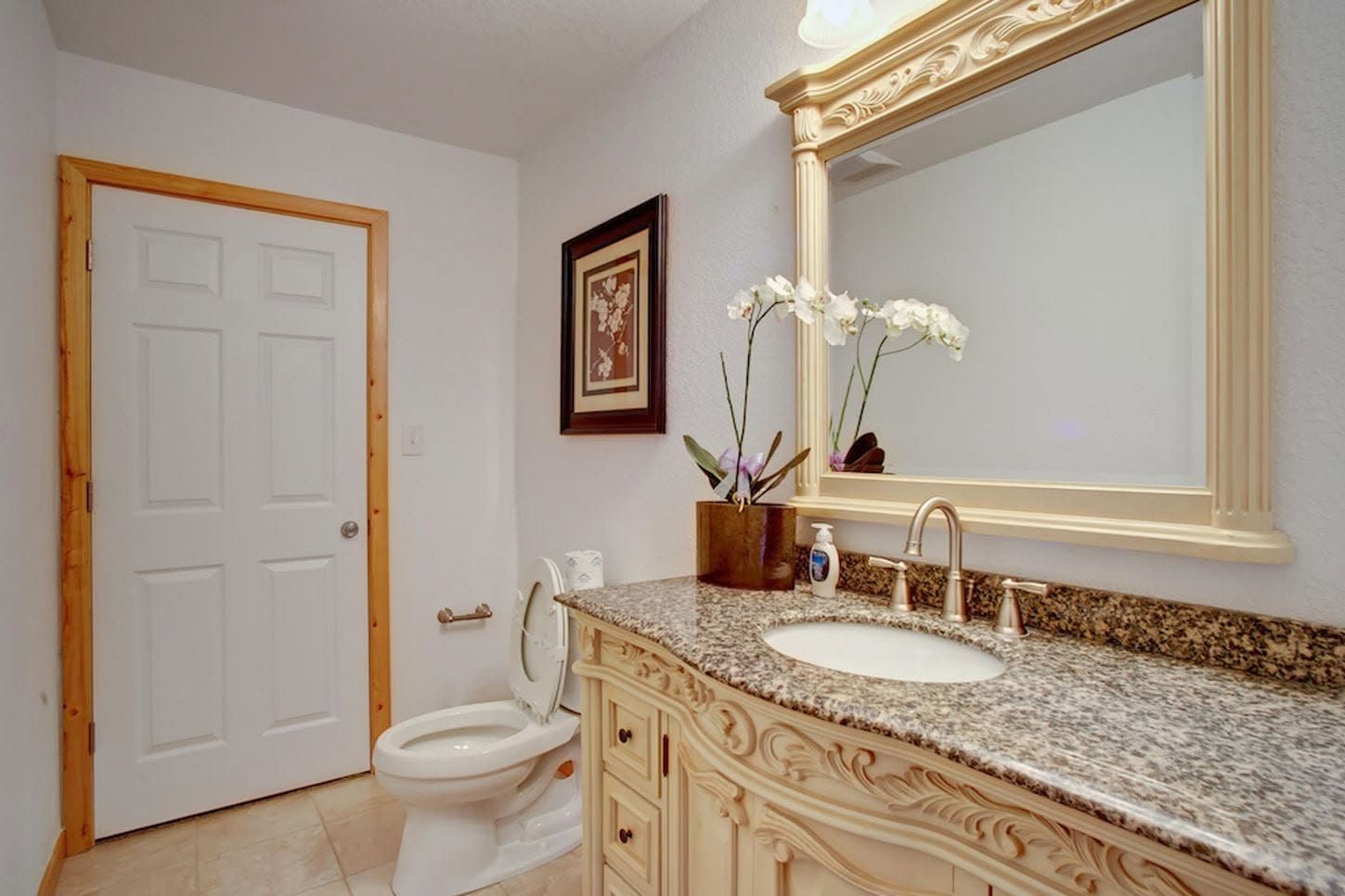 En-suite bathroom with carved vanity and granite counter
