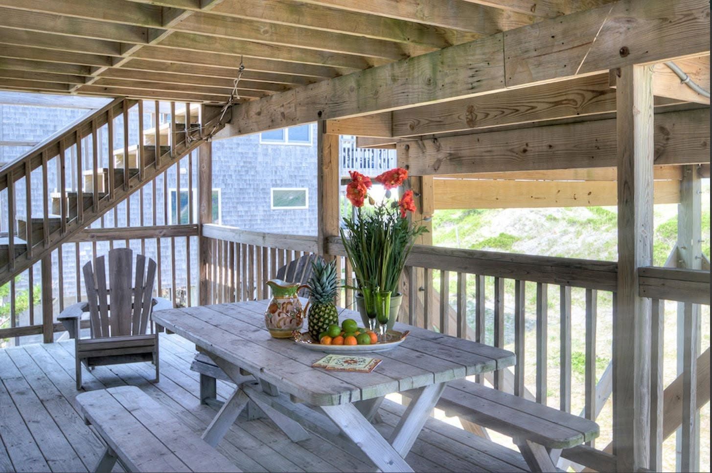 Covered deck with picnic table and dune views