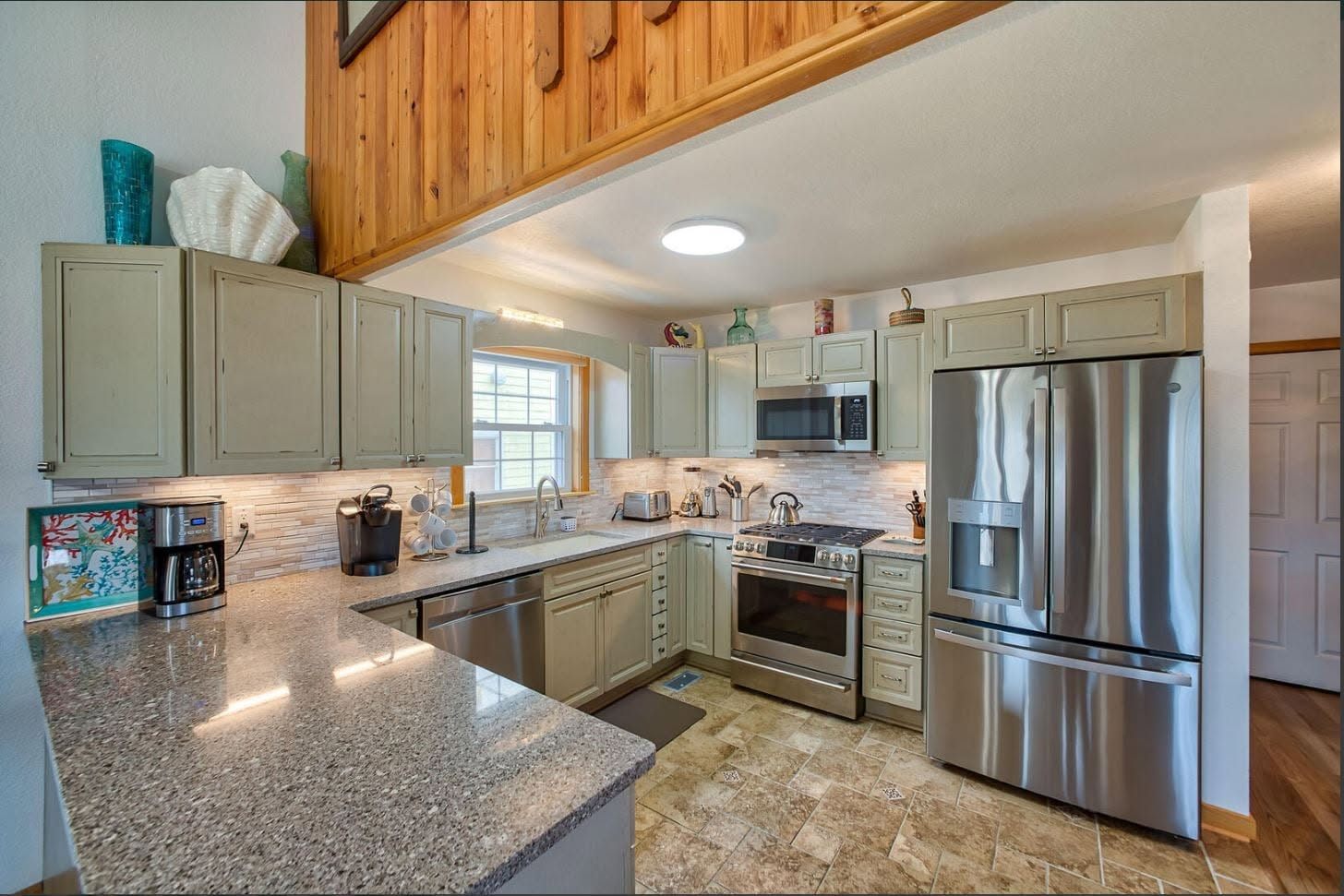 Open kitchen with granite counters and stainless appliances