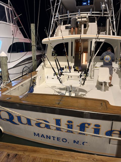 Qualifier tied up at the dock before dawn, rods rigged